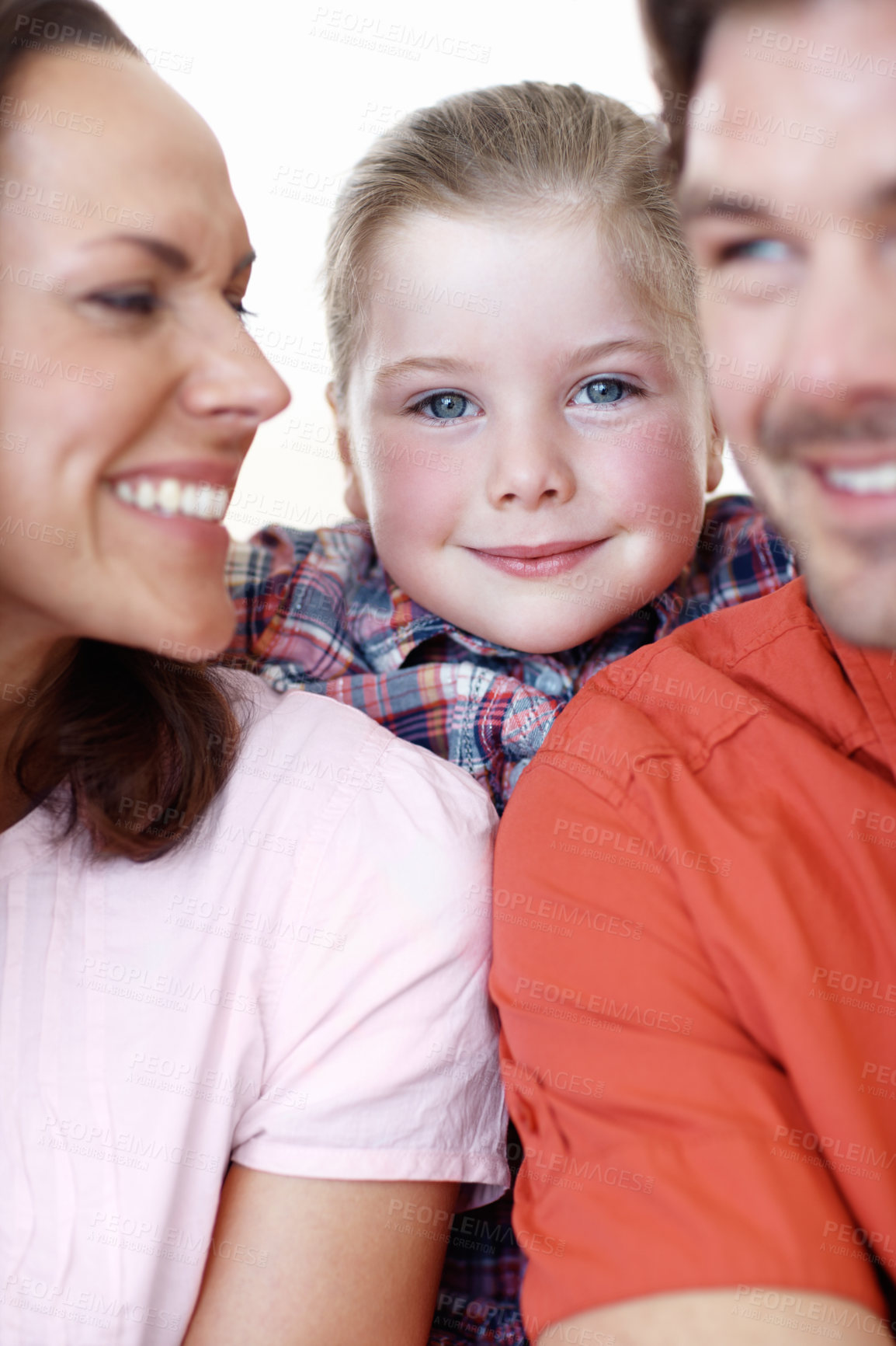 Buy stock photo A young girl smiles, framed be her parents