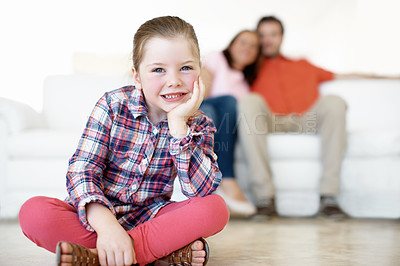 Buy stock photo A little girl poses with her parents in the background