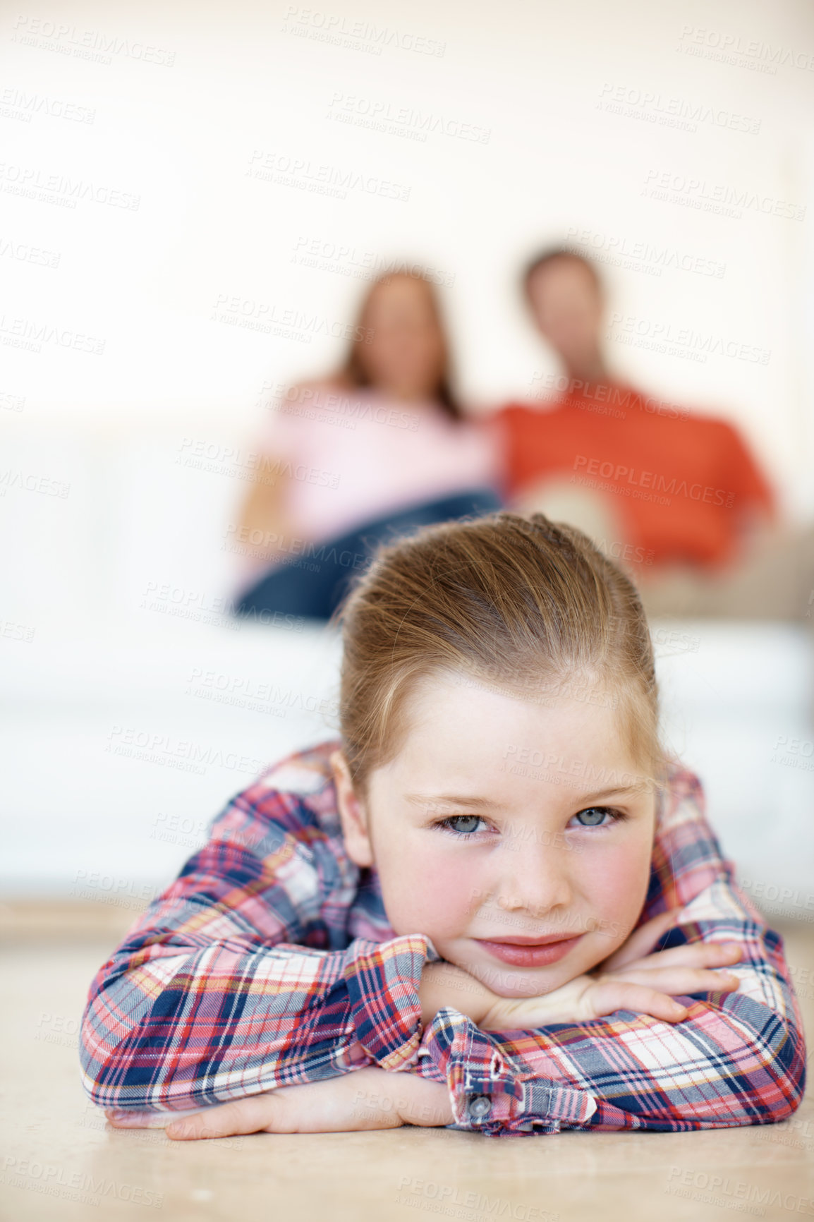 Buy stock photo A young girl lies on her arms on the floor