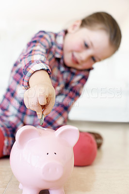 Buy stock photo Focus on a little girls hadn putting coins in a piggybank