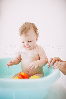 Buy stock photo A baby girl enjoying her time in the bathtub