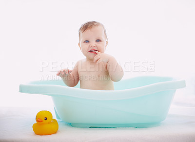 Buy stock photo A cute baby girl sitting happily in the bathtub