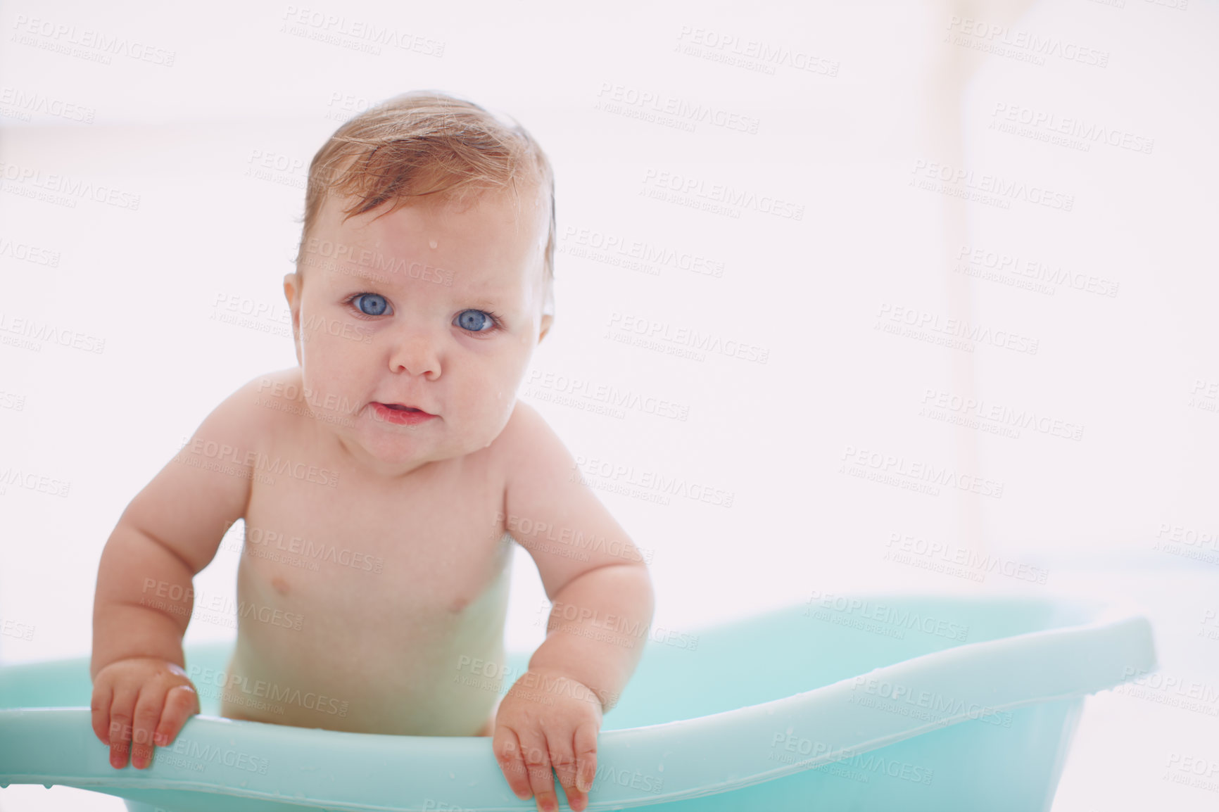 Buy stock photo A cute baby girl sitting happily in the bathtub