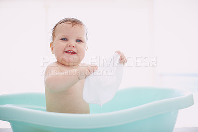 Buy stock photo A cute baby having fun in the bathtub