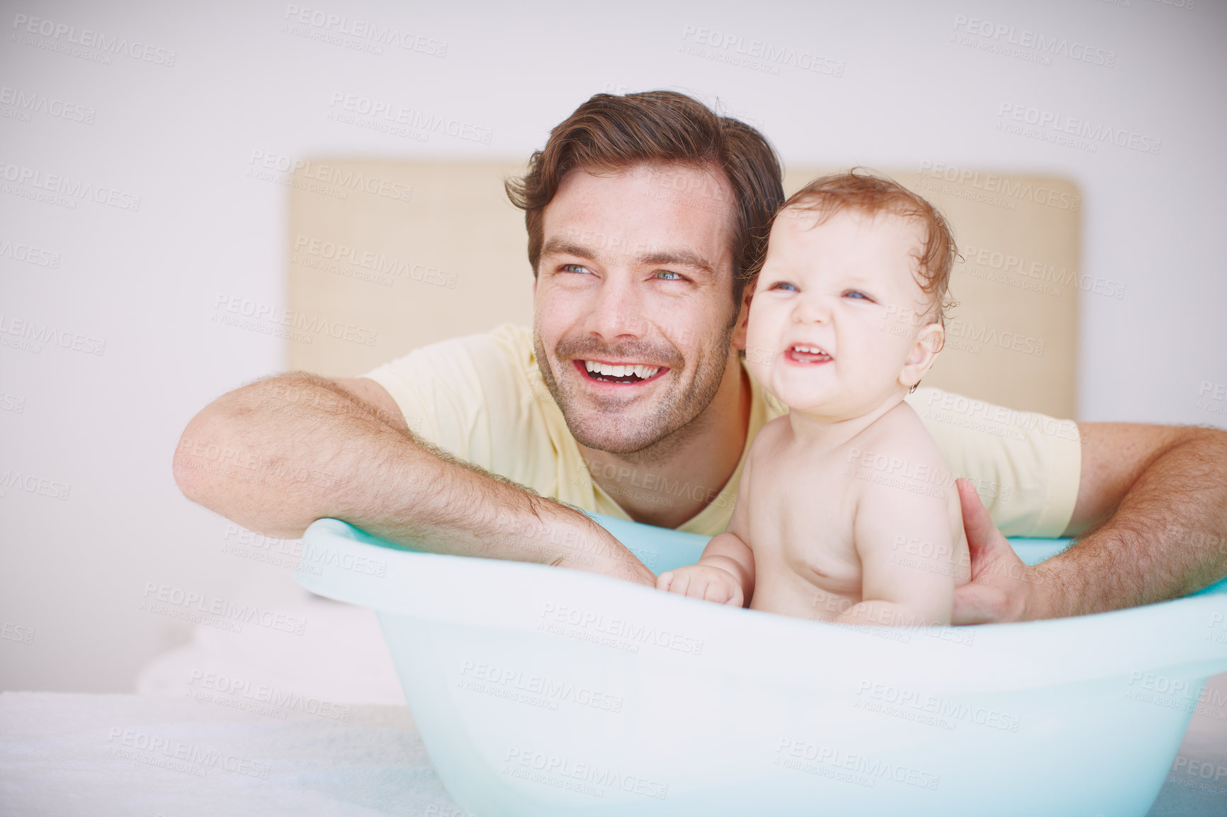 Buy stock photo A young father bonding with his baby daughter at bathtime 