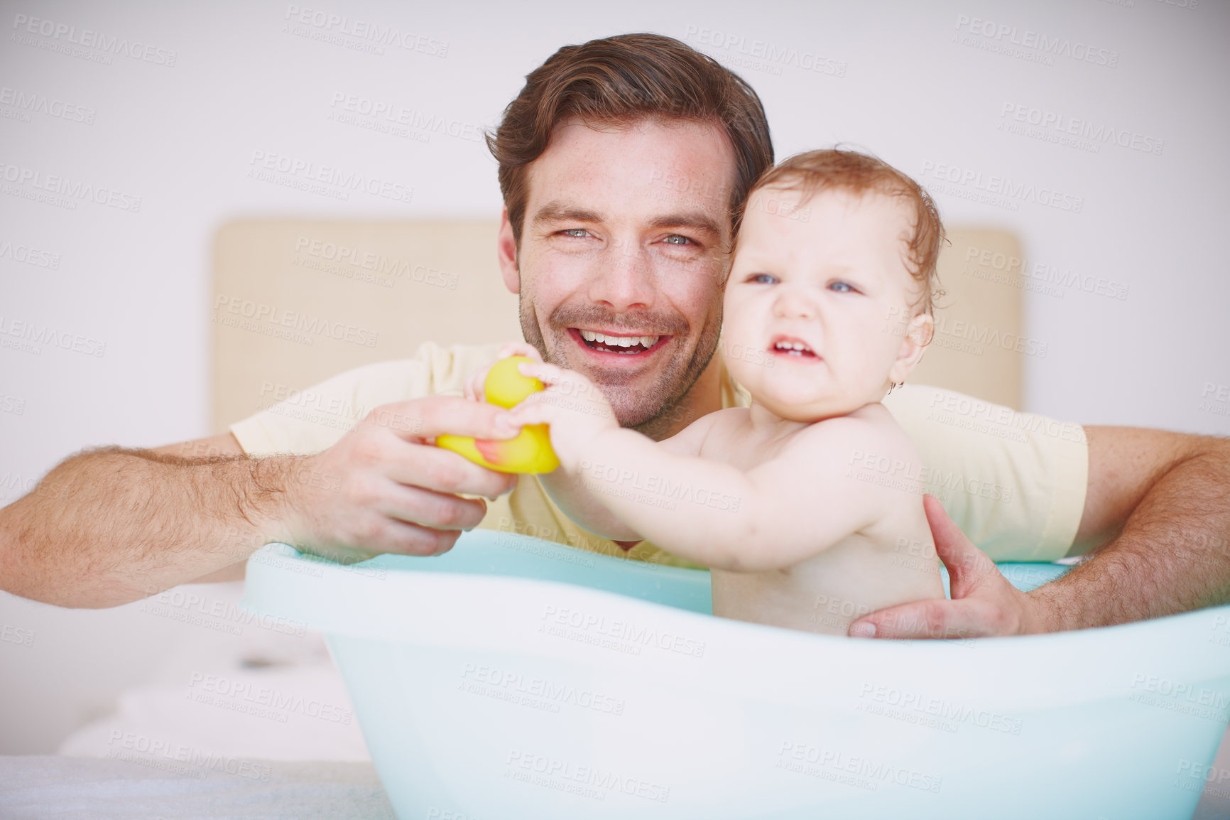 Buy stock photo Portrait of a young father bonding with his baby daughter at bathtime 