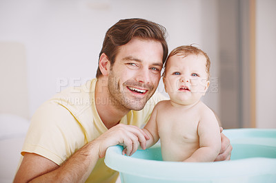 Buy stock photo Portrait of a young father bonding with his baby daughter at bathtime 