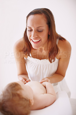 Buy stock photo A young mother showing her baby daughter affection