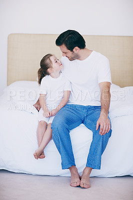 Buy stock photo A little girl sitting on a bed next to her dad