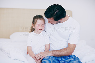 Buy stock photo Shot of of a father and daughter spending time together while sitting on a bed