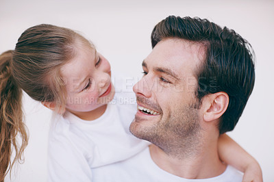 Buy stock photo A little girl lovingly embracing her father around the neck