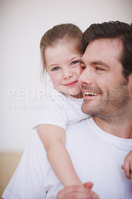Buy stock photo A cute little girl lovingly embracing her father around the neck