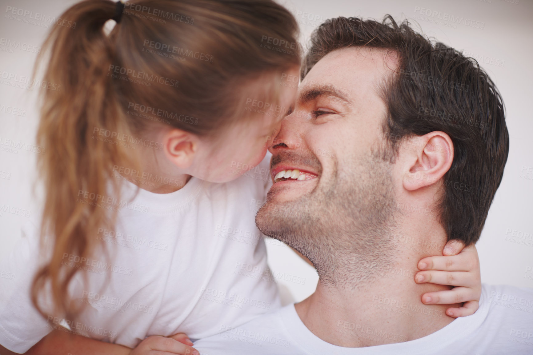 Buy stock photo A father and his young daughter showing each other affection