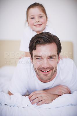 Buy stock photo Shot of a little girl sitting on her father's back