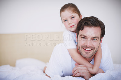 Buy stock photo Portrait of a little girl embracing her dad around the neck from behind