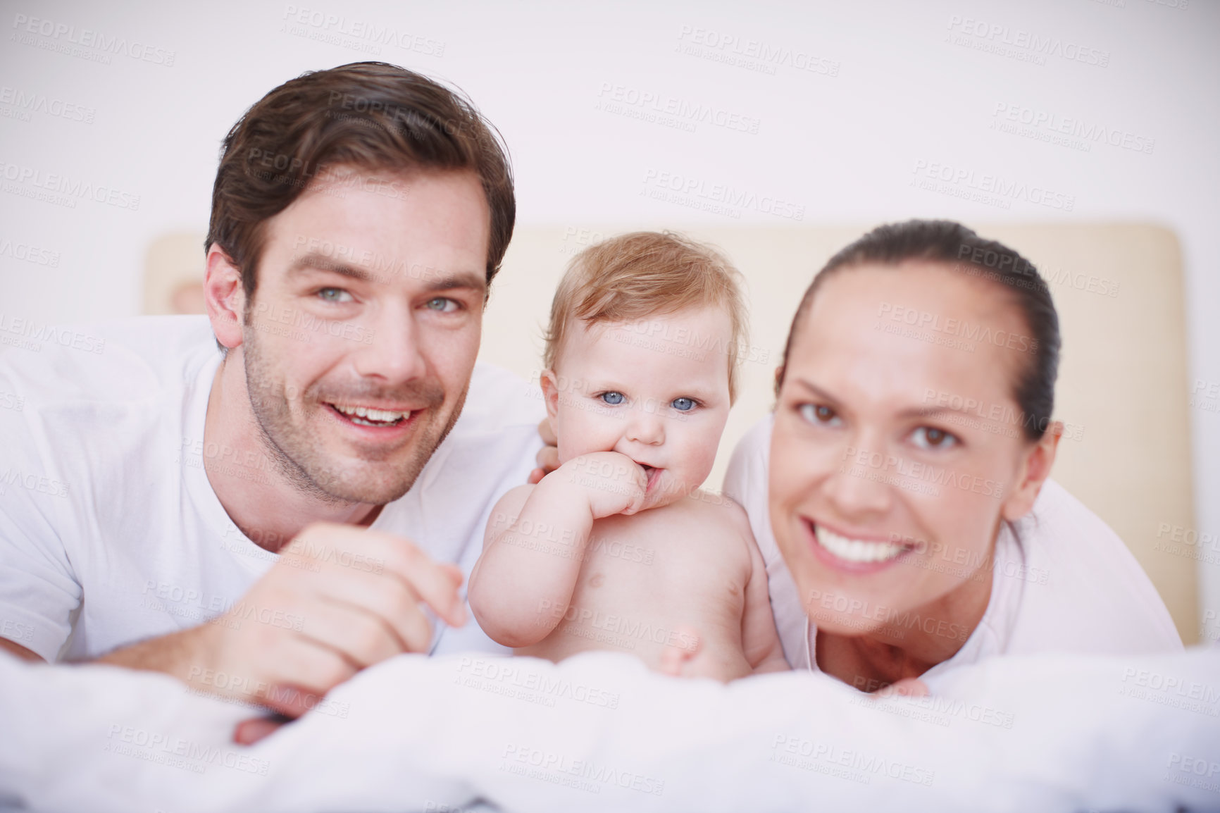 Buy stock photo Two loving young parents and their adorable baby girl