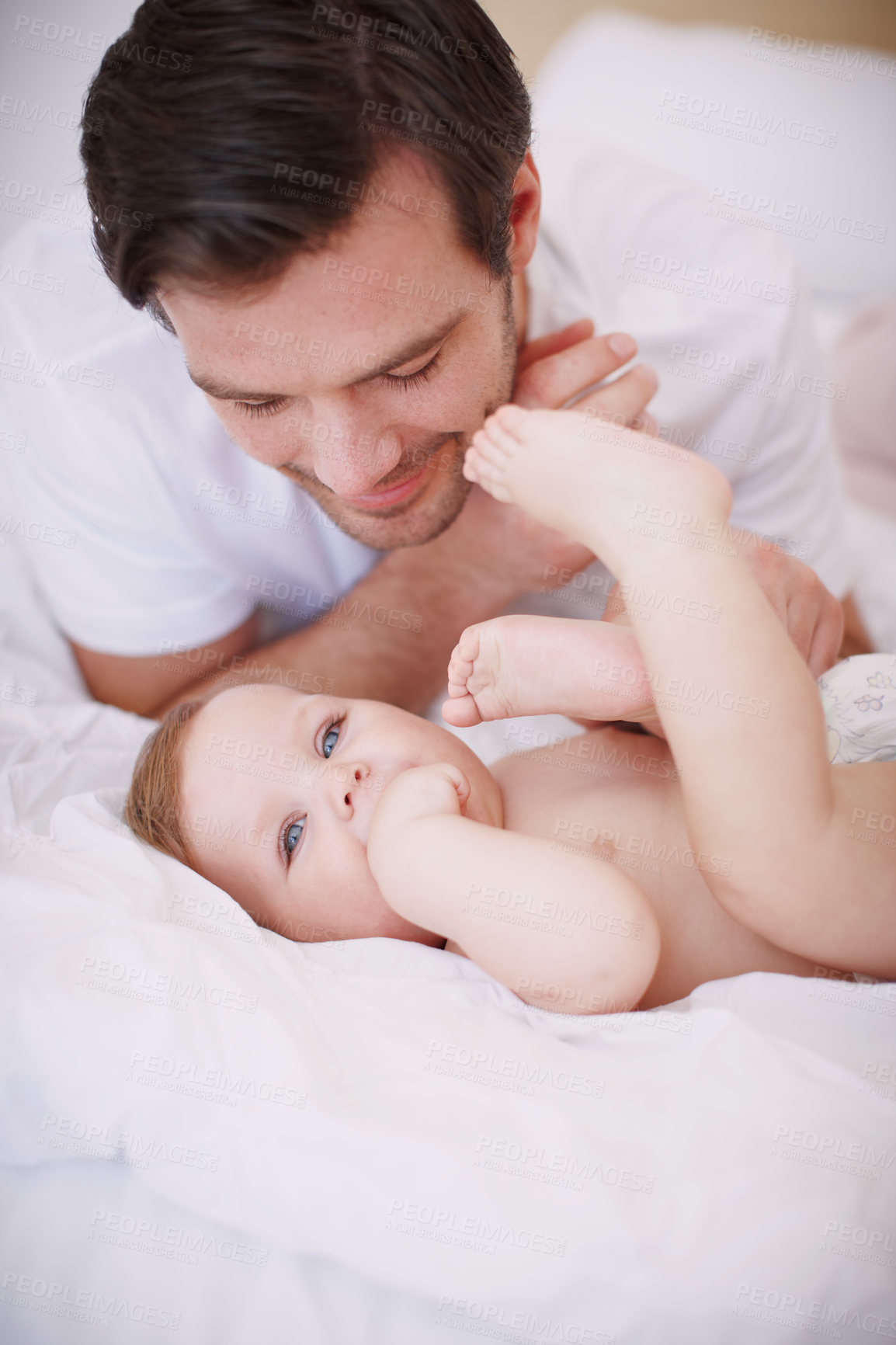 Buy stock photo A devoted young dad spending time with his baby daughter