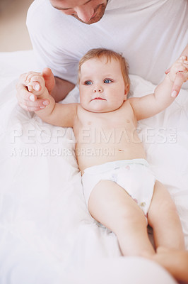 Buy stock photo A devoted young dad spending time with his baby daughter