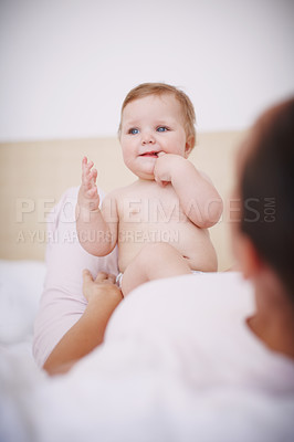 Buy stock photo A cute baby girl sitting on her mother's stomach