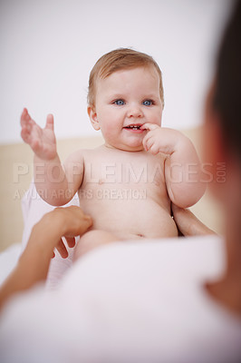 Buy stock photo Closeup shot of a cute baby girl having fun while sitting with her mother