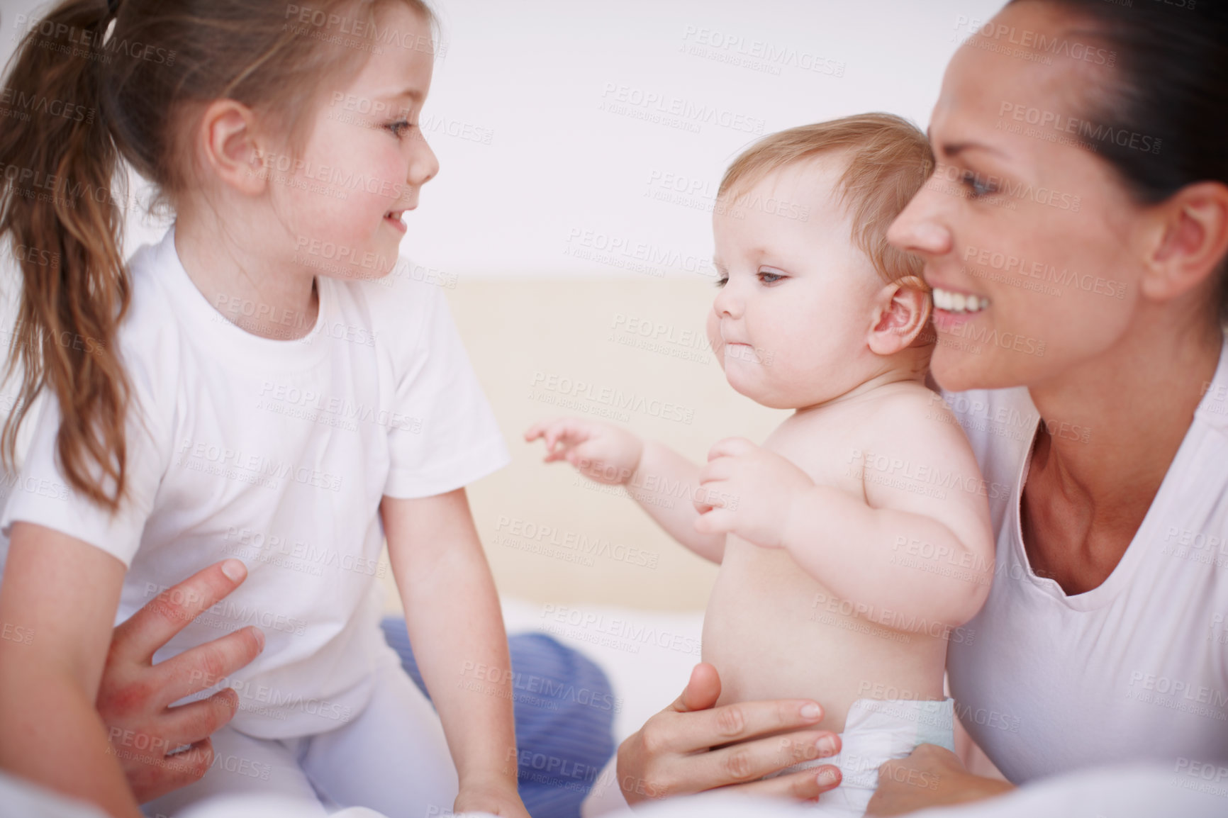 Buy stock photo Cropped shot of a young mother spending time with her two daughters indoors