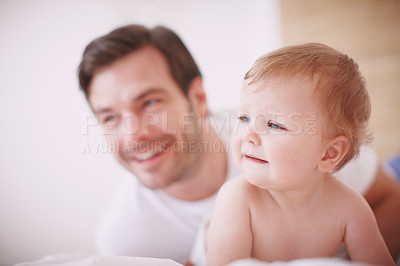 Buy stock photo A devoted young dad spending time with his baby daughter indoors