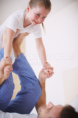 Buy stock photo Shot of a dad playing with his young daughter indoors