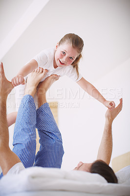 Buy stock photo Low-angle view of a father playing with his young daughter