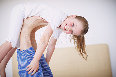 Buy stock photo Portrait of a young girl propped up on her father's feet
