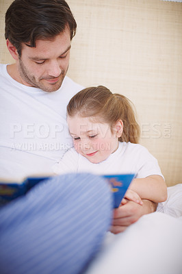 Buy stock photo Relax, father and child in bedroom for reading book, learning and bonding with cognitive development. Sleepy, girl and dad with storytelling for language support, fantasy and literacy hobby at home