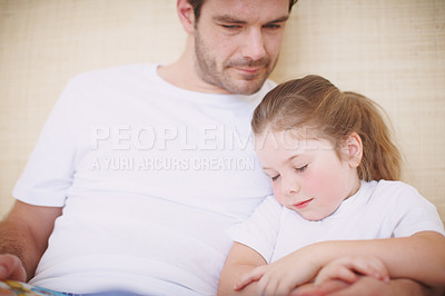 Buy stock photo Shot of a devoted father siting with his young daughter while she falls asleep