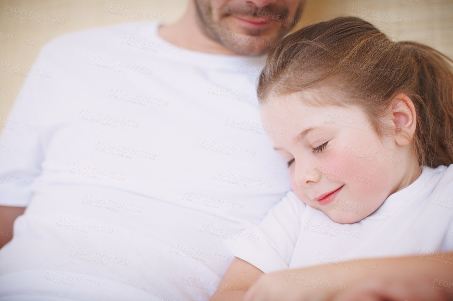 Buy stock photo Cropped view of a father siting with his young daughter while she falls asleep