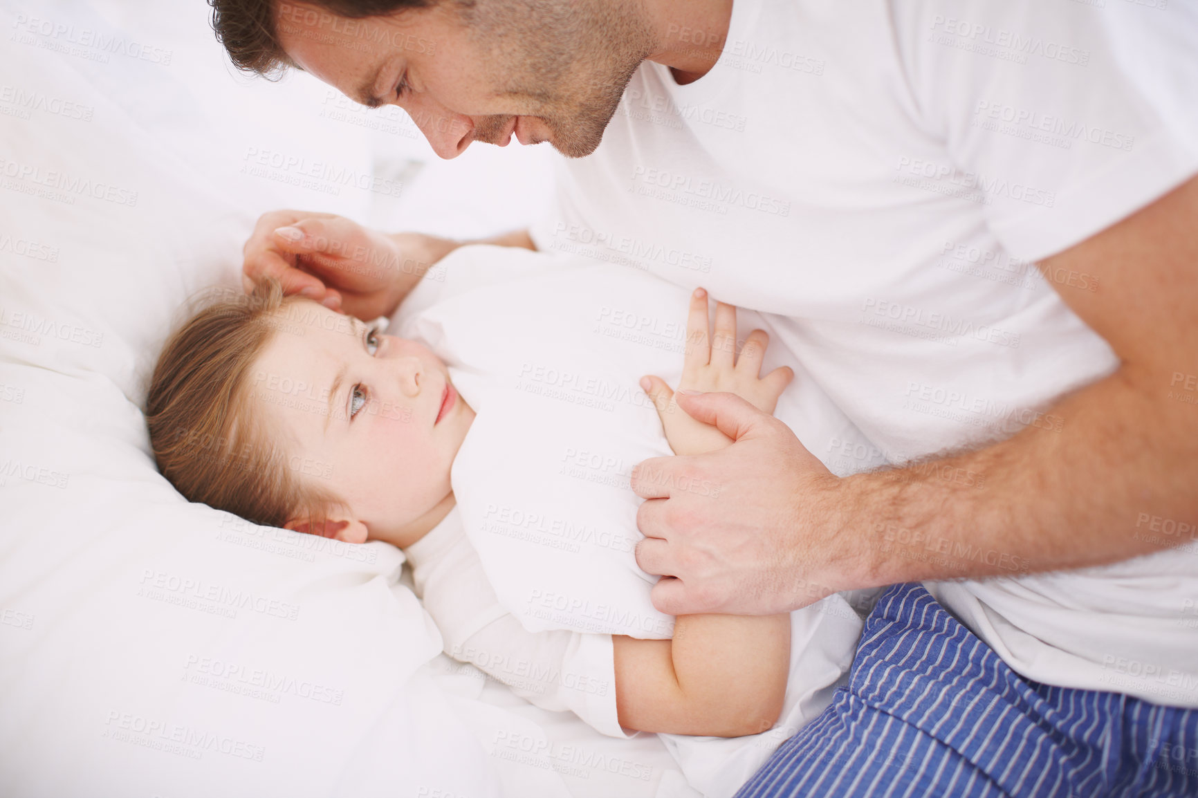 Buy stock photo A dad saying goodnight to his young daughter