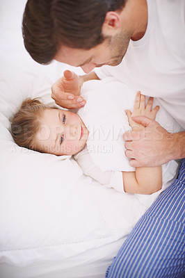 Buy stock photo High-angle view of a dad putting his daughter to bed