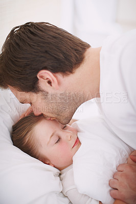Buy stock photo A dad putting his daughter to bed