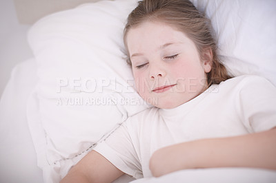 Buy stock photo Shot of a little girl sleeping peacefully in her bed