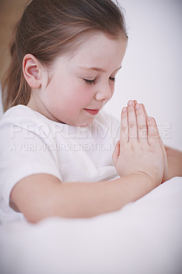 Buy stock photo Closeup of a young girl saying her prayers before bedtime