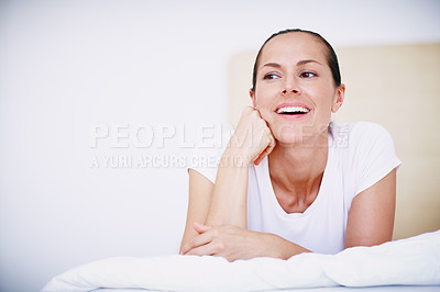 Buy stock photo An attractive woman lying on her bed and looking happy