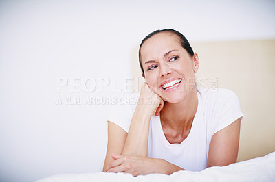 Buy stock photo A beautiful woman relaxing on her bed and looking thoughtful