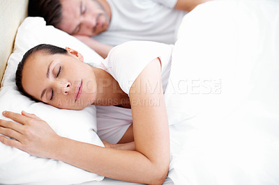Buy stock photo A young couple peacefully sleeping next to each other