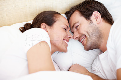 Buy stock photo Portrait of a young couple relaxing in bed