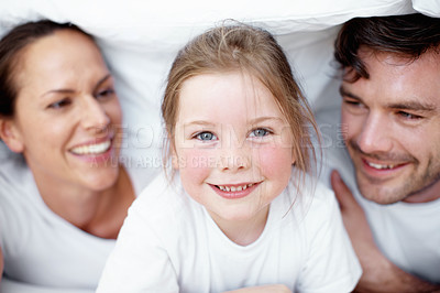 Buy stock photo Bed, parents and duvet with child in portrait, bonding together and happiness with linen for cover. Home, mother and father with girl for relax, comfortable and childhood with wellness on weekend