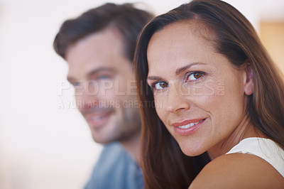 Buy stock photo Portrait of a committed young wife with her husband sitting beside her