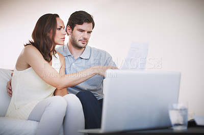 Buy stock photo A young couple going through their personal finances