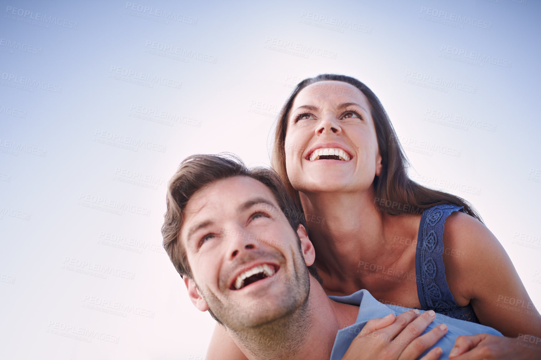 Buy stock photo A handsome man piggybacking his loving wife outdoors