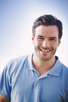 Buy stock photo Portrait of a handsome man smiling happily while standing outside