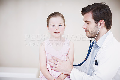 Buy stock photo Shot of a doctor doing a general medical examination on a little girl