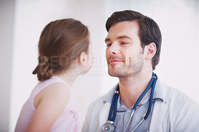 Buy stock photo A male doctor examining a little girl