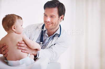 Buy stock photo A young male doctor examining an infant girl