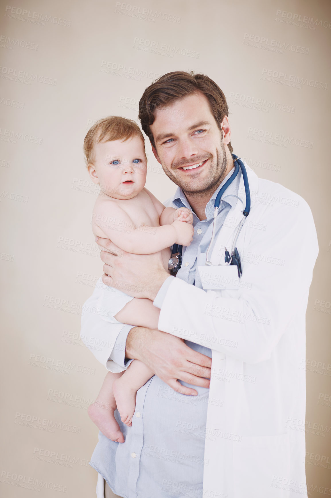 Buy stock photo Portrait of a male doctor holding an infant girl in his arms
